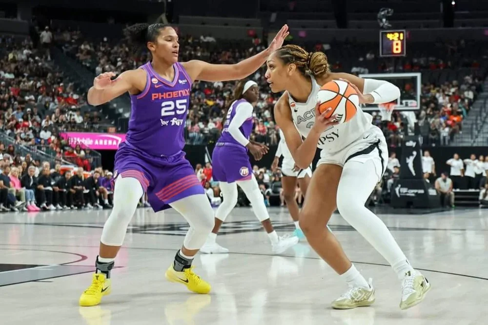 A'ja Wilson is guarded by Alyssa Thomas in a game.