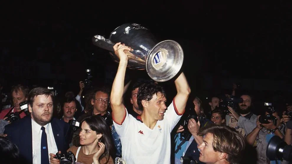 Marco van Basten of AC Milan lifts the trophy after winning the 1990 European Cup final